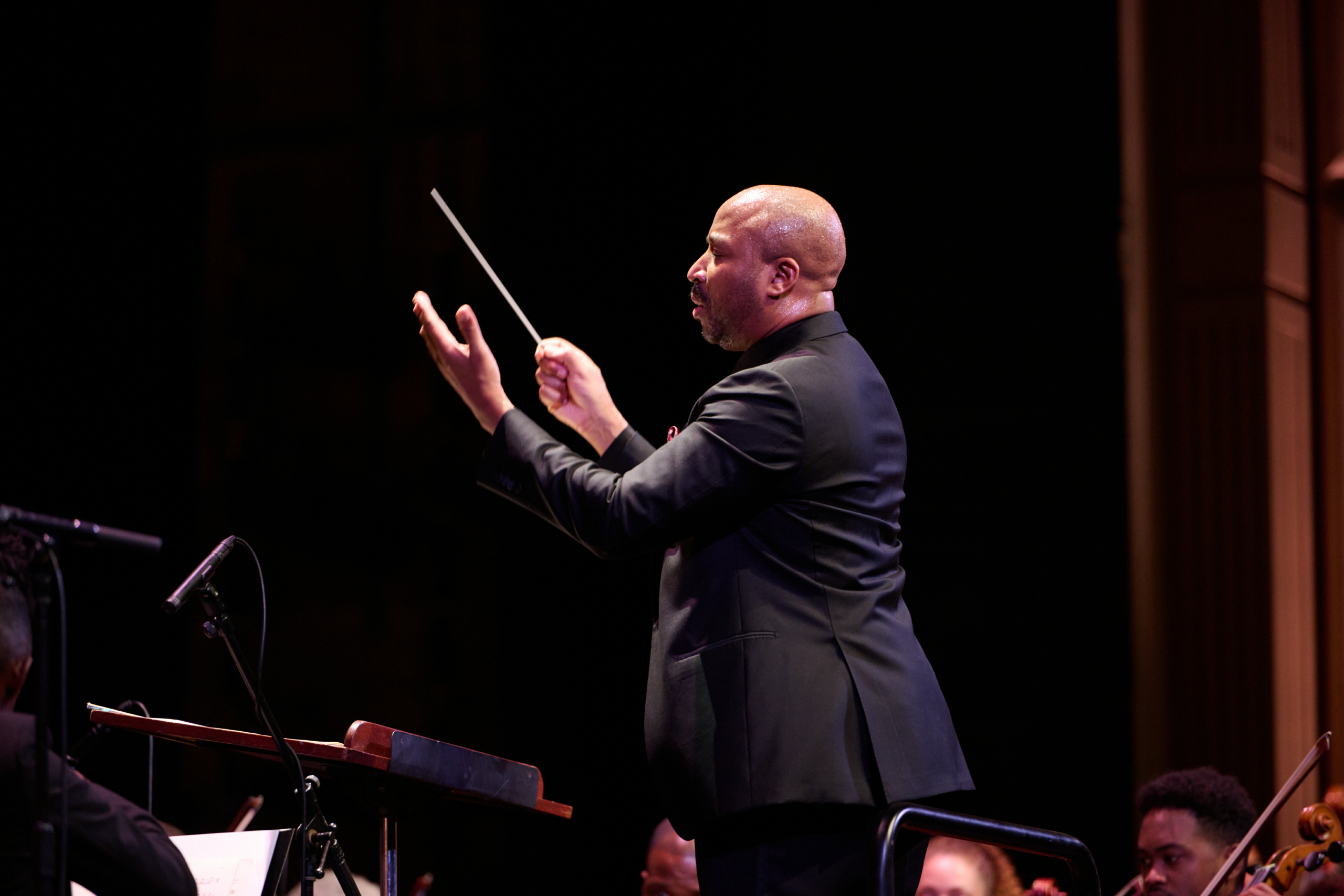 Juneteenth Day conductor instructing his band on stage